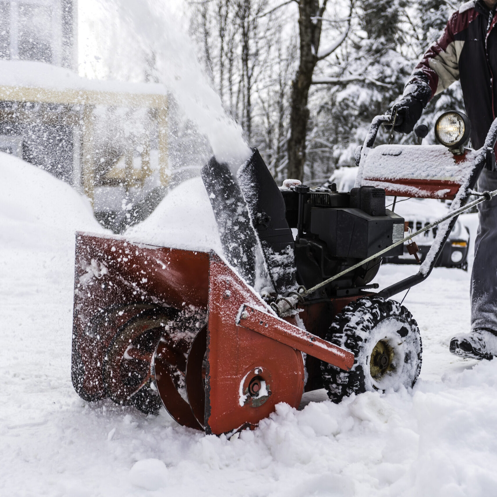 Senior Man Using SnowBlower After a Snowstorm, Quebec, Canada